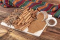 Cinnamon sticks on a wooden background. Cinnamon spice in a spoon and bowl. Ceylon cinnamon. Cinnamon dried bark strips and Royalty Free Stock Photo