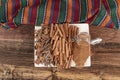 Cinnamon sticks on a wooden background. Cinnamon spice in a spoon and bowl. Ceylon cinnamon. Cinnamon dried bark strips and Royalty Free Stock Photo