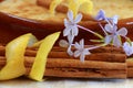 Cinnamon sticks wrapped in lemon peel with a bowl of rice pudding Royalty Free Stock Photo