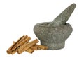 Cinnamon with a stone pounder on white