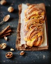 Cinnamon twisted loaf bread or babka on a dark wooden background