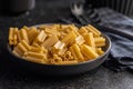 Cinque buchi. Uncooked italian pasta in bowl on black table Royalty Free Stock Photo
