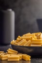 Cinque buchi. Uncooked italian pasta in bowl on black table Royalty Free Stock Photo