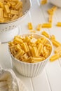 Cinque buchi. Uncooked italian pasta in bowl on white table Royalty Free Stock Photo
