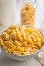 Cinque buchi. Uncooked italian pasta in bowl on white table Royalty Free Stock Photo