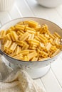 Cinque buchi. Uncooked italian pasta in colander on white table Royalty Free Stock Photo