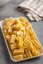 Cinque buchi. Uncooked italian pasta on plate on kitchen table Royalty Free Stock Photo