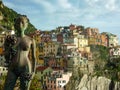 Cinque Terre - Bronze Lady of the Grapes statue with scenic view of small fishermen town of Manarola
