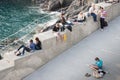 Young adults travelers relaxing by sea sitting around checking t