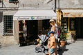 Seaside village Vernazza, old souvenir shop and tourist people in Cinque Terre, Italy