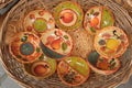 Cinque Terre, Italy - colorful ceramic bowls displayed on a basket. Local souvenirs sold in Riomaggiore.