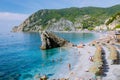 Chairs and umbrellas fill the spiaggia di fegina beach , the wide sandy beach village of Monterosso Italy, part of the