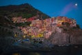 Cinque Terre, Italy - night view of the colorful pastel houses in Manarola, a seaside village on the rugged Italian Riviera coast. Royalty Free Stock Photo