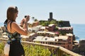 Cinque Terre, Italy - 15th August 2017:Girl taking photos with h Royalty Free Stock Photo