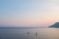 Cinque Terre, Italy - three yachts on the sea at sunset. View from Vernazza, a seaside village on the Italian Riviera coast. Royalty Free Stock Photo