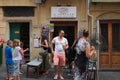 Cinque Terre, Italy - tourists outside Il Pescato Cucinato, a popular restaurant in Riomaggiore which sells mixed seafood cones.