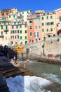Cinque Terre village Riomaggiore with colorful houses and people bathing