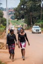 Young African female students walking on road side