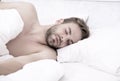 Circadian rhythm regulates sleep wake cycle. Man handsome unshaven guy in bed. Enough amount sleep every night. Tips Royalty Free Stock Photo