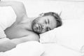 Circadian rhythm regulates sleep wake cycle. Man handsome unshaven guy in bed. Enough amount sleep every night. Tips Royalty Free Stock Photo