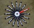 Circle of black ballpoint pens with a red one Royalty Free Stock Photo