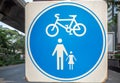 Circle blue and white road sign on white square steel plate for pedestrian and bicycle zone Royalty Free Stock Photo