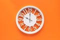 Circle clock on orange background wall