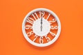 Circle clock on orange background wall