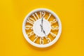 Circle clock on yellow background wall Royalty Free Stock Photo
