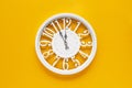 Circle clock on yellow background wall Royalty Free Stock Photo