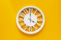 Circle clock on yellow background wall Royalty Free Stock Photo