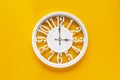 Circle clock on yellow background wall