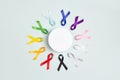 Circle of colorful awareness ribbons with place for text on blue background. World cancer day concept, February 4