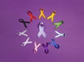 Circle of colorful awareness ribbons on purple background. World cancer day concept, February 4