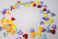 A circle of colorful little hearts. In the center of the circle there is an empty light space for tex Royalty Free Stock Photo
