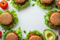 Circle composition of vegan quinoa burgers with avocado and vegetables Royalty Free Stock Photo