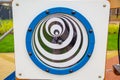 A circle with concentric ellipses on a wooden shield on the playground in kindergarten on a clear sunny day.