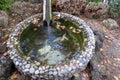 Circle decorative pond with pebble wall Royalty Free Stock Photo