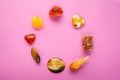 A circle of different minerals on pink background. Spiritual amber, calcite, Aragonite, Simbercite, Jasper, Tiger`s eye