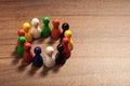 Circle of diversity, figurines on wood table Royalty Free Stock Photo