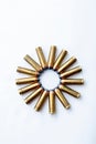 A circle formed by several brass bullets, ammunition for a revolver.