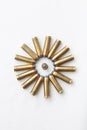 A circle formed by several brass bullets, ammunition for a revolver.