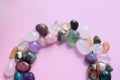 The circle is lined with natural minerals. Semi-precious stones of different colors, raw and processed. Amethyst, rose quartz, Royalty Free Stock Photo