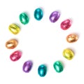 Circle made of chocolate easter eggs wrapped in multi colored foil isolated on white background Royalty Free Stock Photo