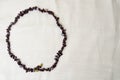 The circle is made of female beautiful beads, necklaces of brown dark stones, amber with a background of beige fabric Royalty Free Stock Photo