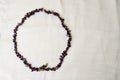 The circle is made of female beautiful beads, necklaces of brown dark stones, amber with a background of beige fabric Royalty Free Stock Photo