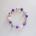 circle made od vivid violet, mettalic silver and snowy white baubles. Christmas copy space.Advent