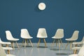 Circle of modern design chairs with one odd one out. Job opportunity. Business leadership. recruitment concept. Royalty Free Stock Photo