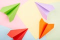 Circle of origami color paper planes on the color background