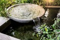 Circle shape water fountain and water fall in garden or park. Royalty Free Stock Photo